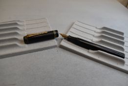 A Wyvern plunger fill fountain pen in black with two narrow band to the cap having Warrented nib.