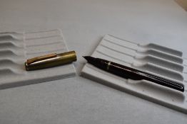 A Mentmore 46 button fill fountain pen in dark red, with silver cap . Approx 13.3cm. Silver rubber