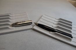 A Sheaffer Imperial III plunger fill fountain pen in black with a steel cap having a Sheaffer nib.