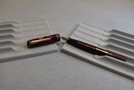 A Burnham leverfill fountain pen in pink marble with one band to the cap having a Burnham 1st nib