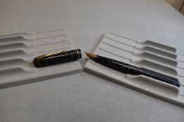 A Conway Stewart 759 leverfill fountain pen in dark blue marble with one narrow band to the cap