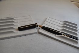 A Conway Stewart leverfil fountain pen in black with single narrow band to the clipless cap having a
