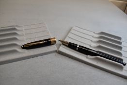 A Sheaffer Valiant Snorkel fill fountain pen in black with a broad band to the cap having a Sheaffer