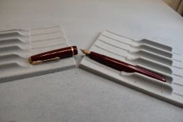 A Parker Slimfold fountain pen in burgundy with single decorative band to cap with Parker 5 nib.