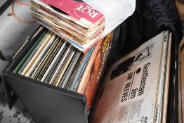 A selection of vinyl albums and 7inch singles including carry case