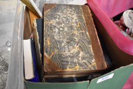 A selection of books and a print of a ducks head