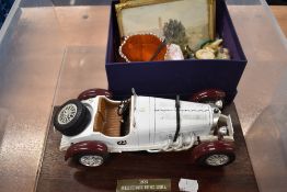 A model car and two watercolours