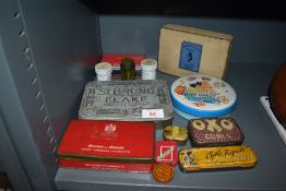 A selection of early 20th century advertising tins including cycle repair and Williams toffee