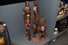 A group of five South African carved wood figures, possibly Massai, each with decorative beadwork.