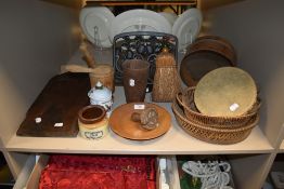 A selection of kitchen hardware including baskets, recipe stand, and bread board