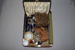 A small selection of curios and trinkets including binoculars, portable ink well and spoons