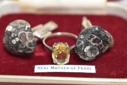 A set of white metal and polished stone cufflinks and a white metal ring stamped silver having a