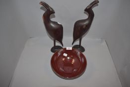 A pair of ethnic wood hand carved bird figures and a studio pottery bowl