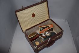 A small stitched card suitcase containing Rolls Razor, Bank of Liverpool & Martins Limited money