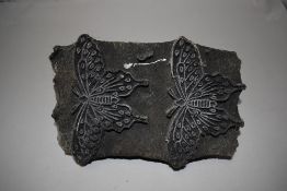 An antique screen printers wood block having carved butterfly or moth decoration