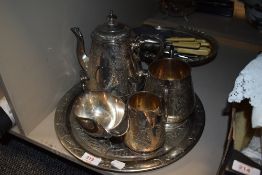 A silver plated tea service having chase work design with similar plated wares including cutlery