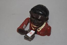 A cast-iron and aluminium 'Jolly Gent' money bank, lacking base insert, damage to tongue, paint