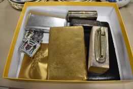 A selection of tobacco smokers accessories including lighters cigarette cases and charoot