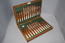 A late Edwardian mother of pearl handled fish knife and fork set