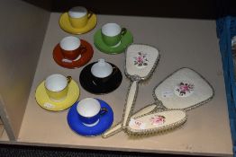 A harlequin coffee cup and saucer set with dressing table set