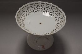 A 19th century porcelain comport having three lions paws to base and repeating pierced pattern to