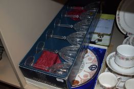 A boxed set of wine glasses by Orchestra also a Coronation plate by Coalport