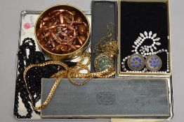 A selection of costume jewellery including gold plated chains, diamante, two strings of mourning