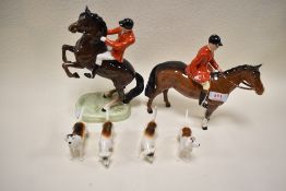 A Beswick huntsman standing, huntsman rearing and four fox hounds.