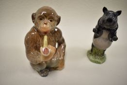 A Beswick figure study of a pipe smoking monkey no. 1049 and similar pig