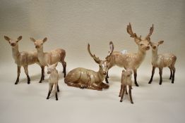 A collection of Beswick Deers; Stag lying down 954, Stag standing 981 Three does 999A and two