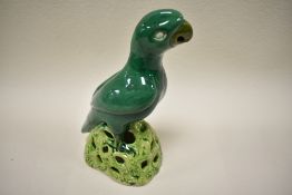 A late 18th / early 19th century green glazed Chinese figure of a parrot perched on top of