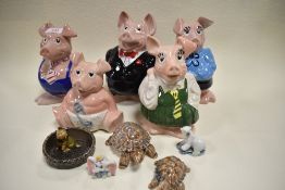 A Wade Piggy bank family, one AF alongside other Wade items.