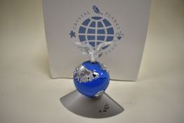 A Swarovski crystal planet vision 2000 designed by Anton Hirzinger.