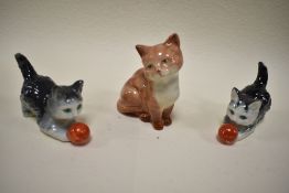 Three cat figures including Beswick seated cat and two Geobels cats playing with ball