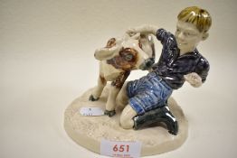 A figure study by Heredities charm of cream ware boy feeding calf