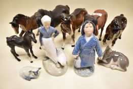 Five Beswick horses; stocky jogging mare, black beauty and mare facing left, black beauty foal,one