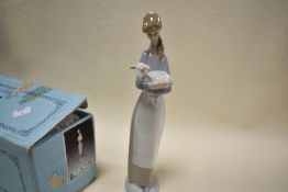 A boxed figure study by Lladro of girl holding lamb
