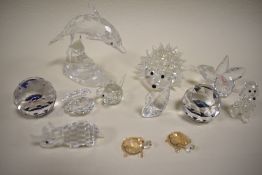 A collection of Swarovski crystal figures to include; flower, Dolphin, Hedgehog and Poodle.
