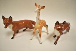 Two Beswick standing fox 1016A, including black tip to tale example and a Giraffe foal Af.