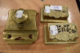 Two small brass stamp cases having an art nouveau design with a similar ink well