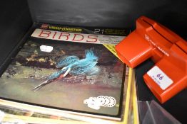 A Gaf view-master and four sets of stereo photos to include birds and wild animals.