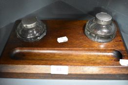 A late 19th/early 20th century mahogany desk top writing set comprising of two ink well and tray.