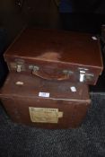 A small vintage leather suitcase with compartmental top and a vintage laundry box