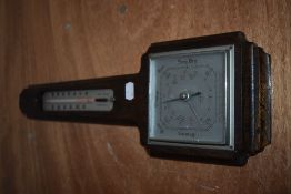 A mid century Smiths oak wall mounted barometer.