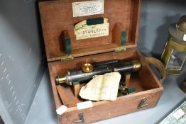 A Stanley three screw level, No 22228 in wooden case with leather handle.
