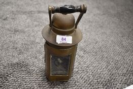 A 1943 dated brass oil lamp with glass door to front and handle, impressed with L.S.CO to lower