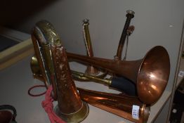 Two copper and brass hunting horns (un-named) two larger examples, a vintage brass car horn and J.