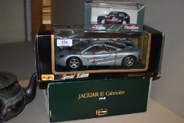Three model die cast cars including Burago Jaguar and Maisto Mclaren