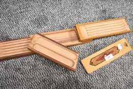 A Beech wood mechanical pen box having various compartments/trays.