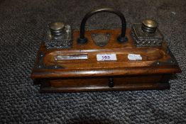 An Edwardian portable desk set in oak with cast fitments and integral drawer